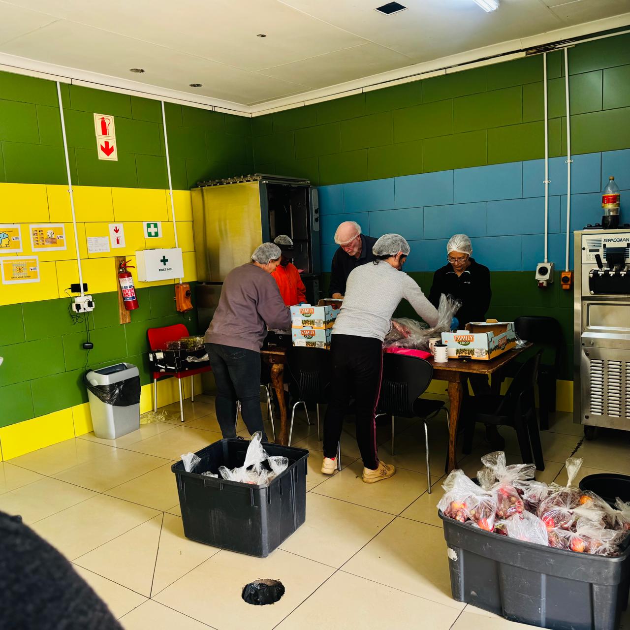 Volunteers packing food parcels for community distribution